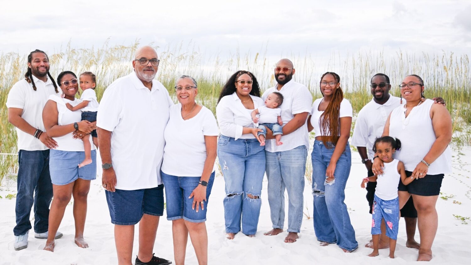 Black family joy captured during a natural light beach session at Henderson Beach State Park.